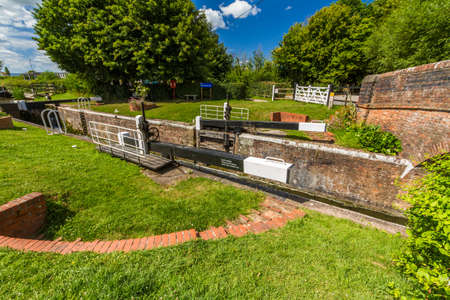 Picturesque canal lock in the UK on sunny summer day. Taunton and Bridgewater Canal, Maunsel Lock,...