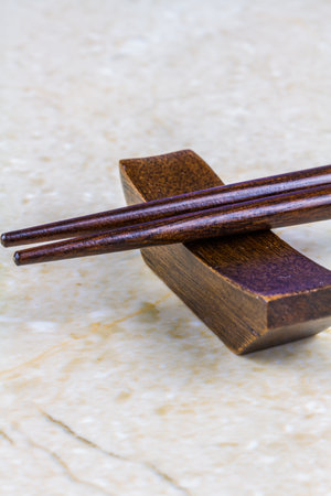 Macro, the ends of two wooden chopsticks on rest, portrait, closeup.の写真素材