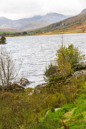 View over Snowdonia lake Llynnau Mymbyr from Capel Curig, portrait, Snowdon in background.の写真素材