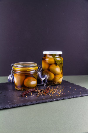 Two jars of eggs pickled in  dark malt vinegar, portrait with copyspace top and bottom.の写真素材