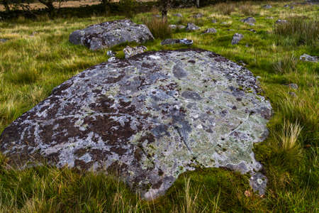 North Wales Rock Cannon, holes in rock or boulder. Gun powder used to make bangs in celebrations landscape with grass.の写真素材