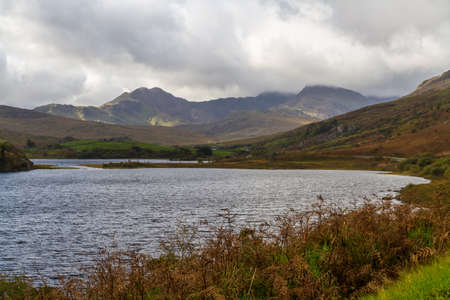 View over Snowdonia lake Llynnau Mymbyr from Capel Curig, landscape, Snowdon in background wide angle.の写真素材