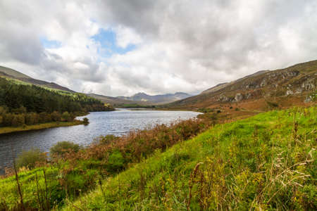 View over Snowdonia lake Llynnau Mymbyr from Capel Curig, landscape, grass in foreground, wide angle.の写真素材