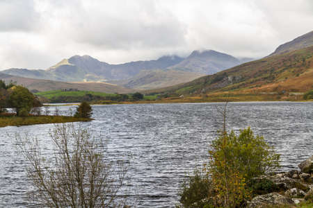 View over Snowdonia lake Llynnau Mymbyr from Capel Curig, landscape, Snowdon in background.の写真素材
