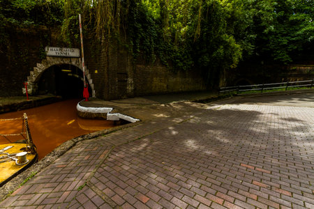 The Trent and Mersey Canal and northern entrance to both Harecastle Tunnels, Kidsgrove, Newcastle-under-Lyme. The water is orange because if clay deposited in the Harecastle Tunnel, landscapeの写真素材