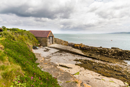 The old lifeboat station or house, now derelict and redundant, Moelfre, Anglesey, North Wales, UK, landscape, wide angleの写真素材