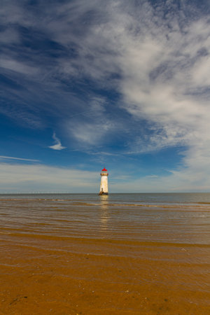 The Point of Ayr or Talacre Lighthouse is on the north coast of Wales, UK, wide angle, copyspace at top, skyの写真素材