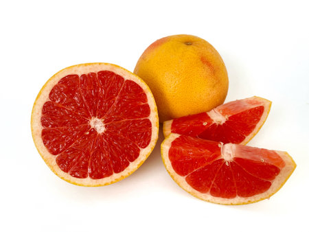 Grapefruit and red grapefruits on a green background.の写真素材