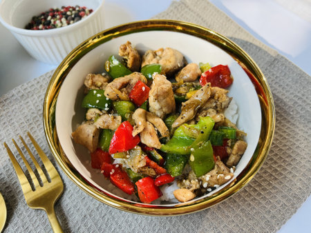 Stir fry chicken with bell pepper and sesame in a bowlの写真素材