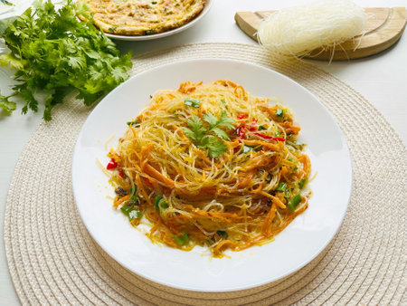 Stir-fried vermicelli with vegetables. Bihun goreng, bee hoon goreng or refers to a dish of fried noodles cooked with rice vermicelli in both the Indonesian and Malayの写真素材