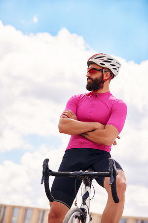 Handsome young man resting after a bike rideの写真素材