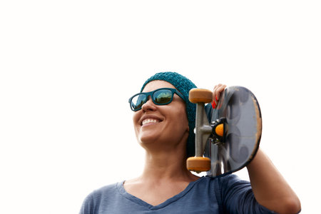 Close up portrait of a young happy woman with a skateboardの写真素材