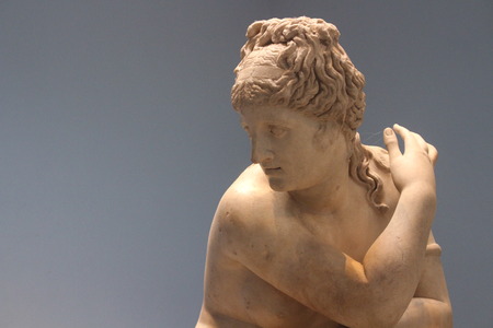 Sculpture of a woman with grey background.の写真素材