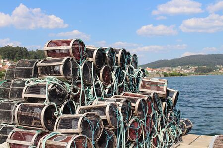 Fishing baskets with nets on the harbourの写真素材