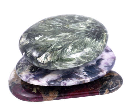 Three small stones stacked one on top of another, on white