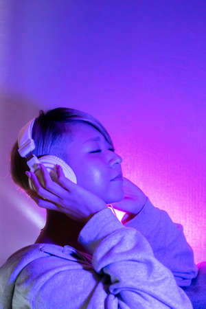 A woman listening to music with headphonesの写真素材