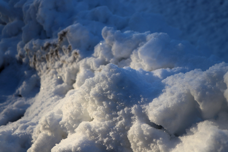 The hill covered white snow with sun raysの写真素材