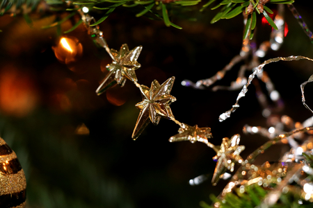 The small golden chain hanging on the christmas treeの写真素材