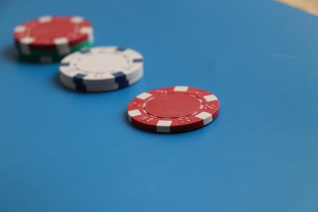 A beautiful red token for gambling on the blue background and play in rouletteの写真素材