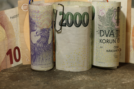 Czech money with a few banknotes euro in small rollの写真素材