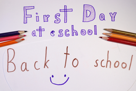 A writing, first day at school with colourful pencils on white paper. Elementary school or crossing on next levelの写真素材