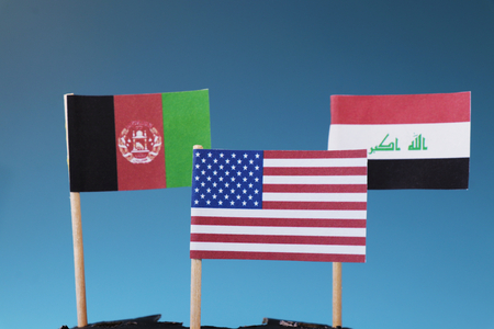 American flag and another two flags of Afghanistan and Iraq. The States where america has his soldiers.  Blue backgroundの写真素材