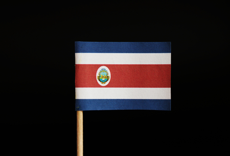 The national flag of the republic Costa Rica on toothpick and on black background. Located in central america. Blue, white and red stripes and in the middle is coat of armsの写真素材