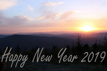 A greeting card with sunrise on the top of Lysa Hora which is located in Czech republic. A sky is playing many colours.の写真素材
