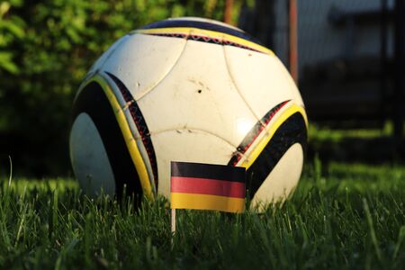 Championship 2022.   National flag of Germany in the playfield with football ball in background. Soccer is the most popular sport.の写真素材
