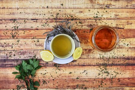 Natural medicine for keep healthy at colds days in autumn. Modern apothecary includes honey, mint leaves, lemons, hot salvia tea and nettle. Special focus on self-care. Traditional herbs.の写真素材