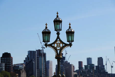 Old-fashioned lights made in middle ages still lighting in night on Westminster bridge. Lamps in this special style, covered with gold are typical architecture of London city.の写真素材