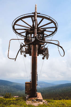 Final stop on the lift. Forgotten ski resort in Hruby Jesenik. Rusty pole with rope at anchor and driving people to the top of the mountain. Nature reserve. Lift abandoned. Czech republic.の写真素材
