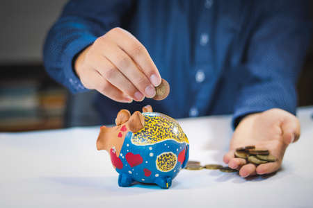 financial advisor puts small coins into a beautiful treasure chest. High interest. Money taken from...