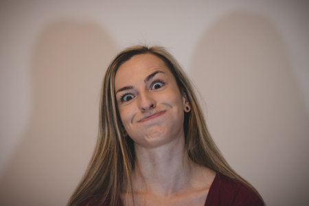 woman of about 25 years and European ethnicity makes funny faces. The girl plucks out her eyes and...