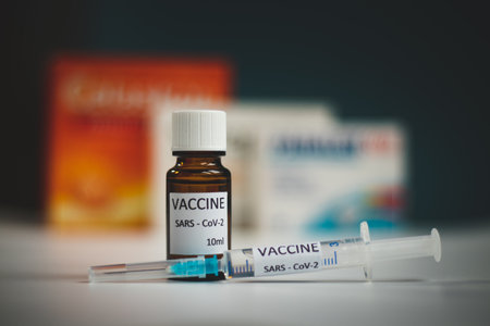 Close-up medical syringe with a vaccine. Vaccine ampoule full of anti-virus medicine, ready for vaccination. A pandemic coronavirus. Vaccination phase.の写真素材
