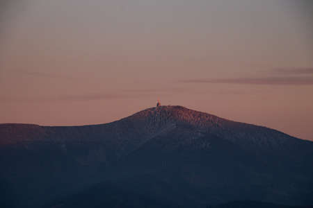 View of Lysa Hora in the early evening light and red-orange tone. Frosty sunset. Beskydy mountain,...
