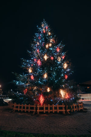 18.12.2021 - Riga. Christmas tree covered with various lights playing red, blue and gold on the main street in the capital of Latvia.のeditorial素材