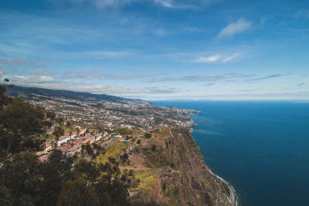 View from the Cabo Girao lookout, the highest cliff in Madeira, of the city of Funchal and the Atlantic Ocean. Aerial view in sunny weather on pure nature.の写真素材