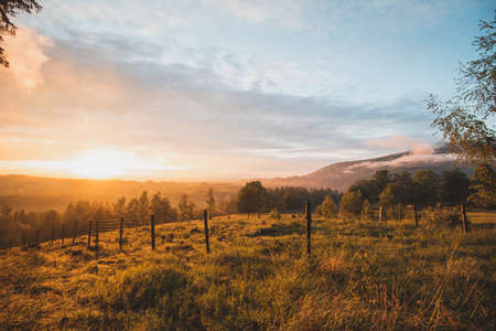 Dramatic sunset over a pristine landscape with an approaching storm from the north over part of Beskydy mountains, czech republic.の写真素材