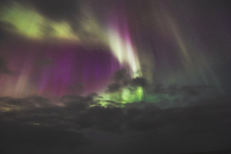 Aurora borealis, northern lights, over Snaefellsnes peninsula, West Iceland. Vibrant green, purple...