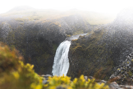Mesmerizing waterfall cascades down moss-covered rocks on the Snaefellsnes peninsula, West Iceland....