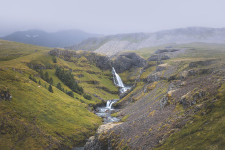 Mesmerizing waterfall cascades down moss-covered rocks on the Snaefellsnes peninsula, West Iceland....