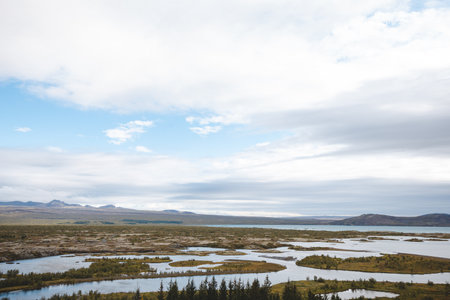 Aerial view over the winding rivers and wetlands of Thingvellir National Park in Iceland, where...