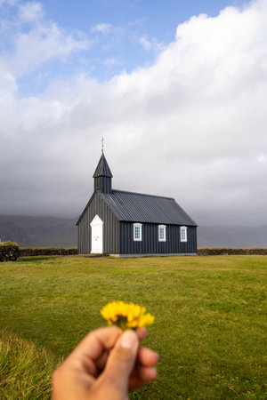 Iconic black Budakirkja church stands in serene solitude beneath misty mountains in Snaefellsbar, western Iceland â a timeless symbol of simplicity and peace.の写真素材