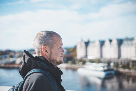Traveler stands on Oslo Opera House, gazing at the city skyline under a blue skyâurban discovery wrapped in crisp Nordic air. Capital city of Norway.の写真素材