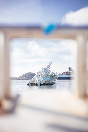 Crystal-like sculpture rises from Oslofjord surface, framed by soft focus and morning lightâart, sea, and sky merging in Norway's capital.の写真素材