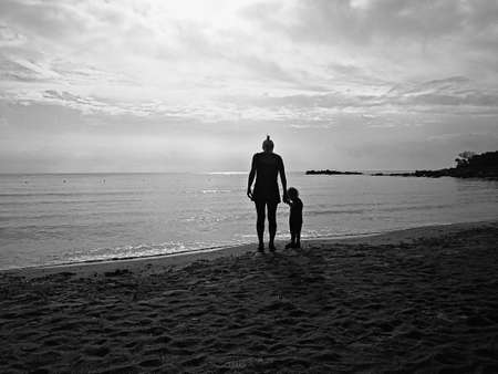 A mom and his son together at the beach in sardinia.の写真素材