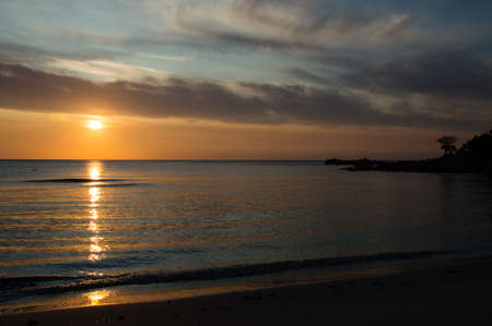 a beautiful sunrise in cala Ginepro, near bidderosa, Sardiniaの写真素材