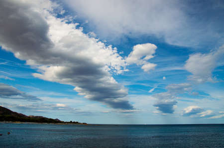 A line of Clouds in Cala Ginepro in Sardinia, Italyの写真素材