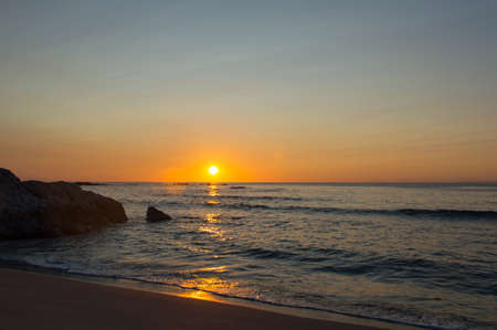 The sun rising up in Cala Ginepro in Sardinia next to Bidderosa, Italyの写真素材